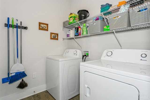 laundry area with dark hardwood / wood-style flooring and washer and clothes dryer