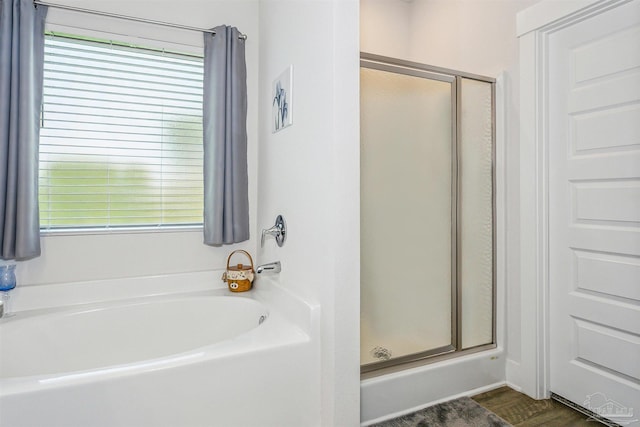 bathroom with wood-type flooring and plus walk in shower