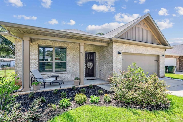 view of front of property with a garage and a porch