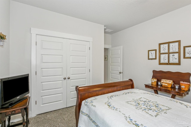 carpeted bedroom featuring a closet