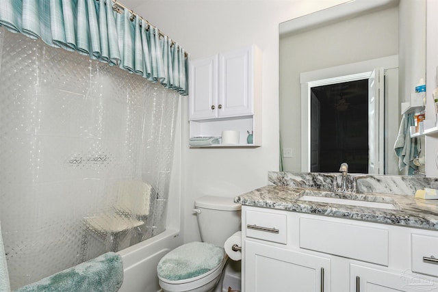 full bathroom with toilet, vanity, and washtub / shower combination