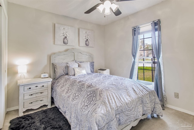 bedroom featuring a ceiling fan, carpet, and baseboards