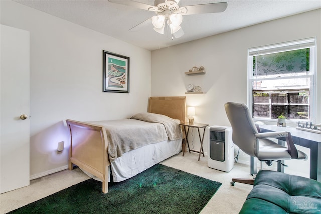 carpeted bedroom with baseboards, a textured ceiling, and ceiling fan