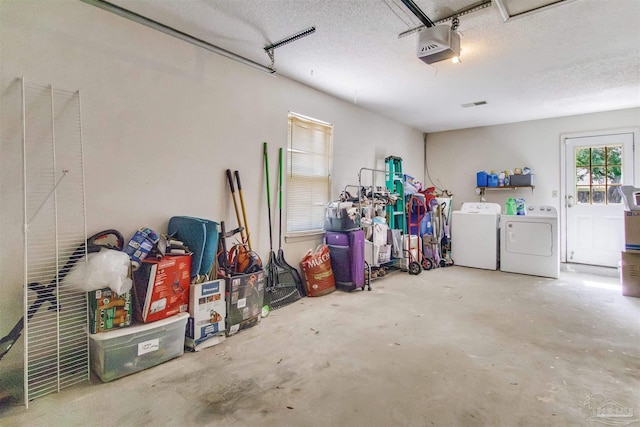 garage with a garage door opener and washing machine and dryer