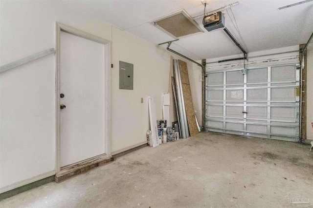 garage with electric panel, a garage door opener, and baseboards