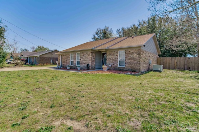 ranch-style home with brick siding, central AC unit, a front yard, and fence