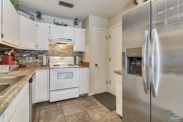 kitchen featuring visible vents, under cabinet range hood, decorative backsplash, appliances with stainless steel finishes, and white cabinetry