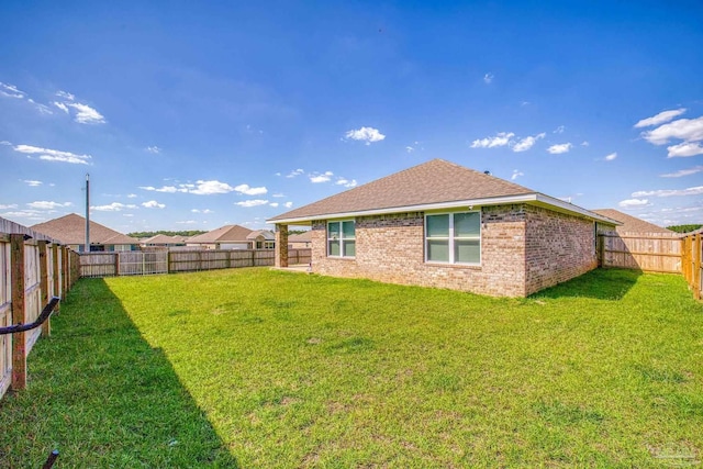 rear view of property with a lawn