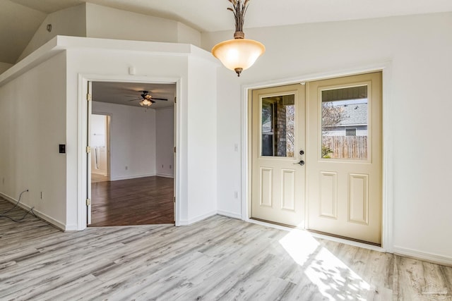 entrance foyer with lofted ceiling, ceiling fan, and light hardwood / wood-style floors