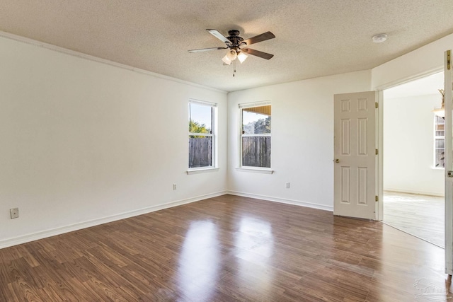 unfurnished room with ceiling fan, a textured ceiling, dark hardwood / wood-style floors, and ornamental molding