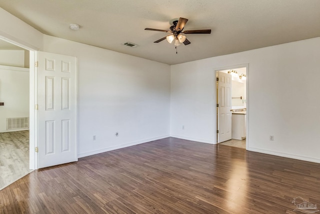 unfurnished room with ceiling fan and dark hardwood / wood-style flooring