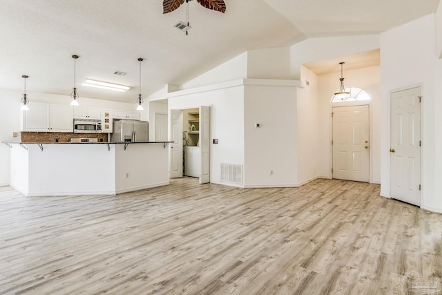 kitchen featuring white cabinetry, kitchen peninsula, ceiling fan, stainless steel appliances, and decorative light fixtures