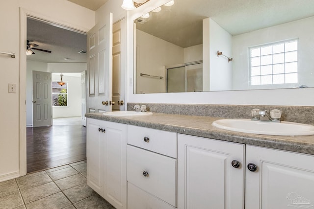 bathroom with ceiling fan, a wealth of natural light, tile patterned flooring, and vanity