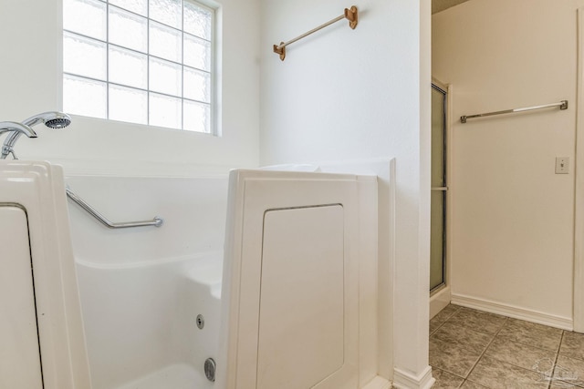 bathroom featuring an enclosed shower and tile patterned flooring