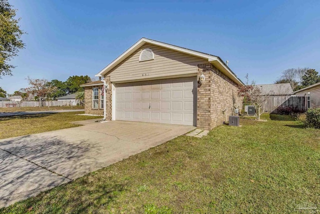 view of side of property featuring a garage, cooling unit, and a lawn