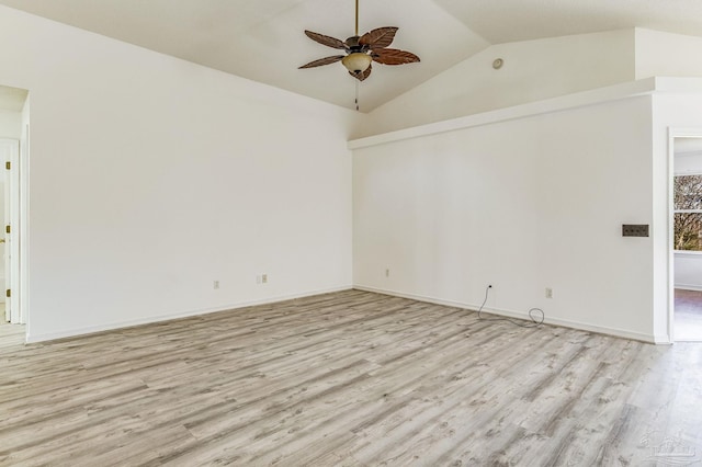 spare room with ceiling fan, vaulted ceiling, and light hardwood / wood-style flooring