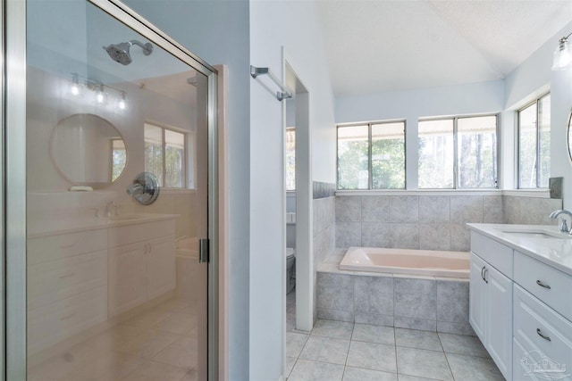 full bath with lofted ceiling, tile patterned floors, vanity, a shower stall, and a bath