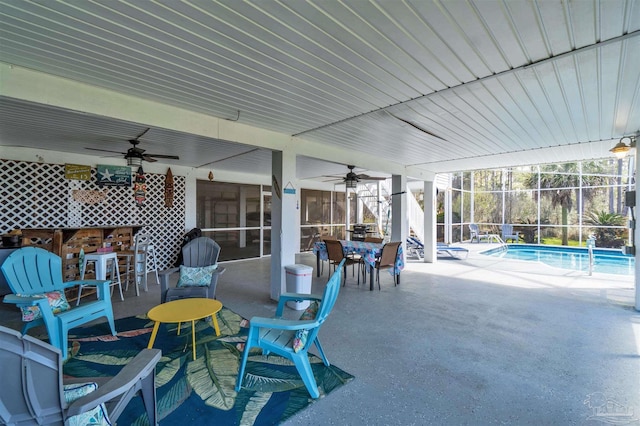 view of patio / terrace featuring an outdoor pool, glass enclosure, and ceiling fan