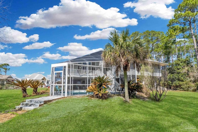 rear view of property featuring glass enclosure, a yard, stairway, and a patio