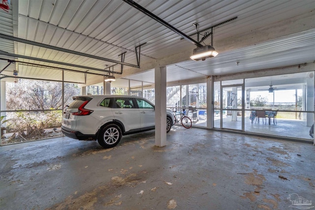 garage with a garage door opener and metal wall