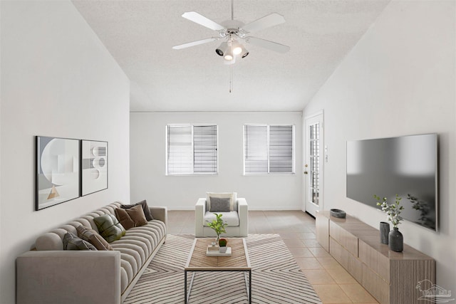 tiled living room featuring a textured ceiling, ceiling fan, plenty of natural light, and vaulted ceiling