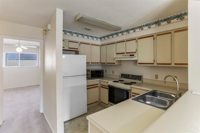 kitchen with cream cabinets, sink, electric stove, kitchen peninsula, and white fridge