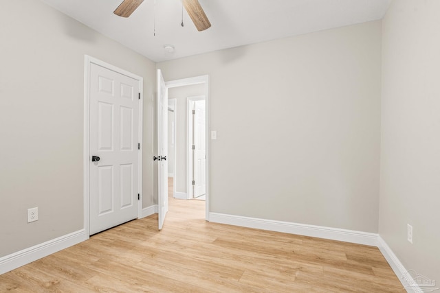 spare room with ceiling fan and light wood-type flooring