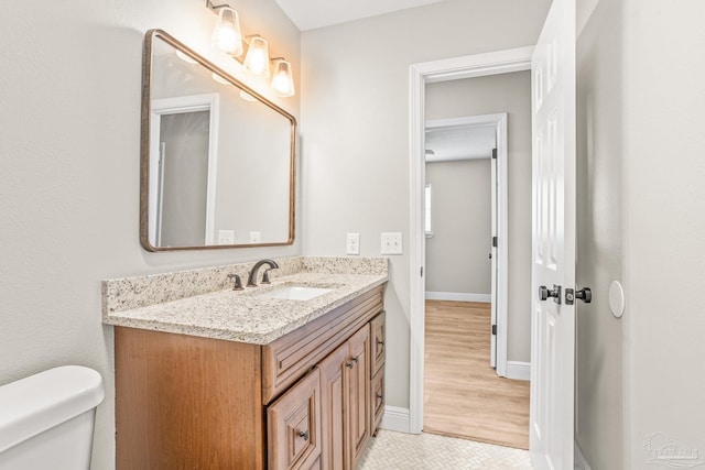 bathroom featuring tile patterned floors, vanity, and toilet