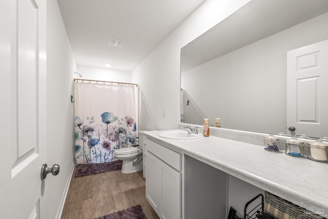 bathroom with vanity, hardwood / wood-style flooring, and toilet