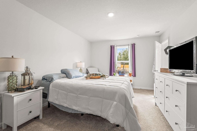 carpeted bedroom with a textured ceiling