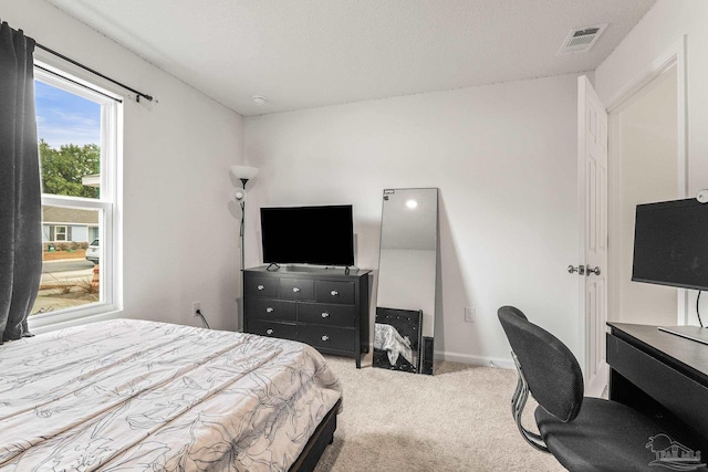 bedroom featuring light colored carpet