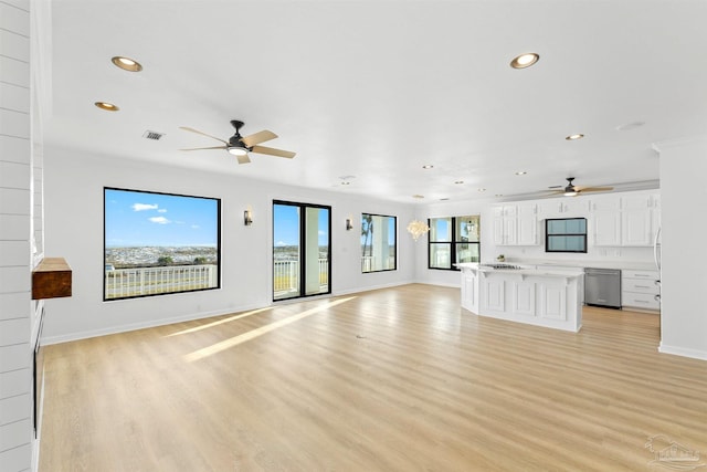 unfurnished living room featuring ceiling fan and light wood-type flooring