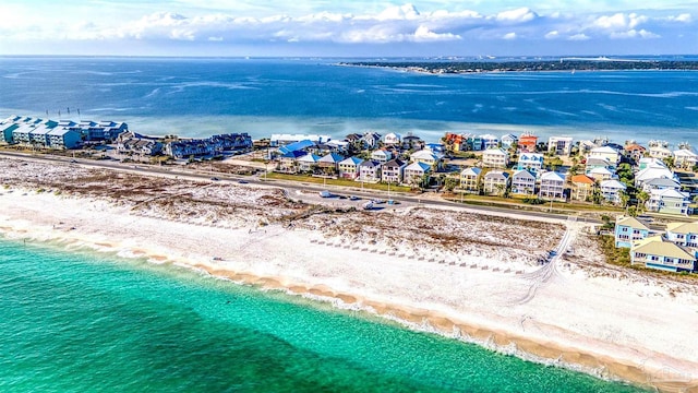 drone / aerial view with a beach view and a water view