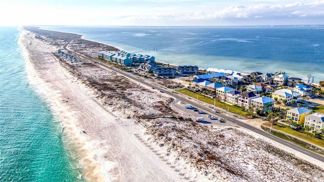 birds eye view of property with a water view and a beach view