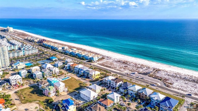 birds eye view of property with a beach view and a water view