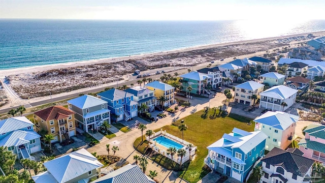 drone / aerial view with a water view and a beach view