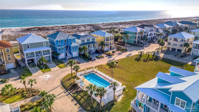 bird's eye view with a water view and a beach view