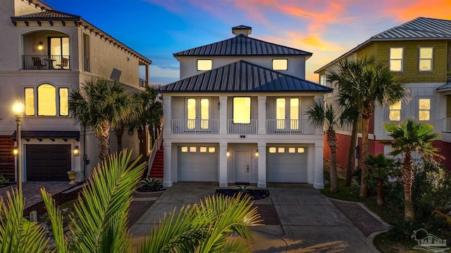 view of front of home with a balcony and a garage