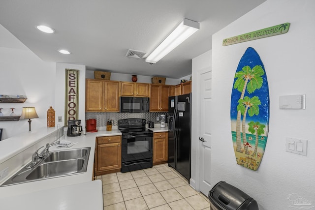 850 Ft Pickens Rd Unit 1230, Pensacola Beach, FL 32561 - kitchen with black appliances, a sink, light countertops, light tile patterned flooring, and decorative backsplash