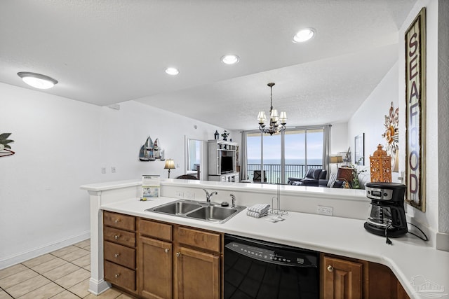 850 Ft Pickens Rd Unit 1230, Pensacola Beach, FL 32561 - kitchen featuring dishwasher, a sink, brown cabinetry, open floor plan, and light countertops