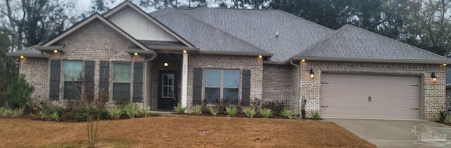 view of front of house featuring brick siding, concrete driveway, roof with shingles, a front yard, and an attached garage