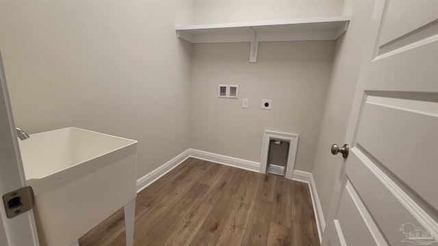 clothes washing area featuring electric dryer hookup, dark wood-type flooring, washer hookup, and sink