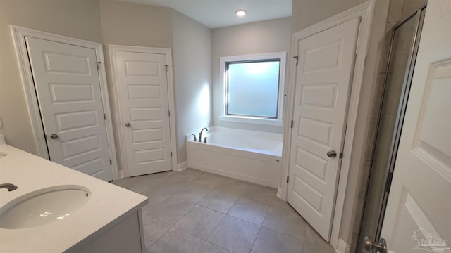 bathroom with tile patterned flooring, vanity, and independent shower and bath