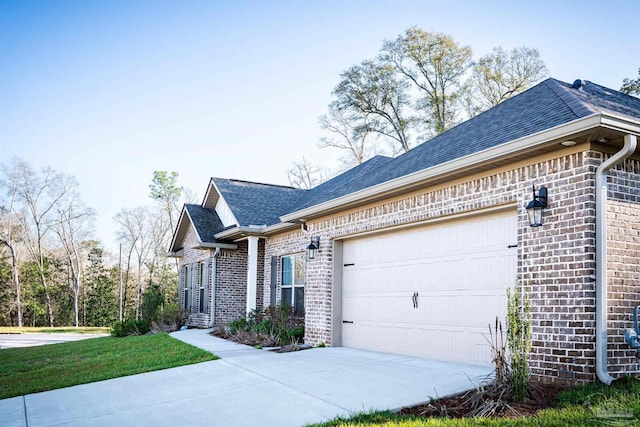 view of home's exterior featuring concrete driveway, an attached garage, brick siding, and roof with shingles