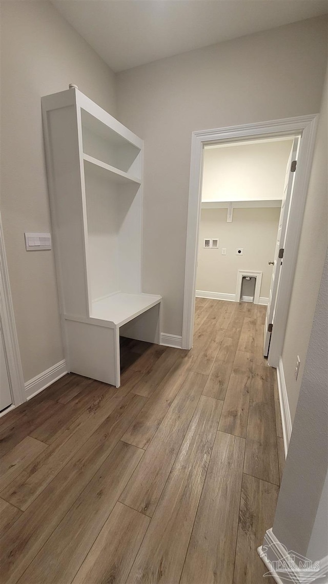 mudroom with visible vents, wood finished floors, and baseboards