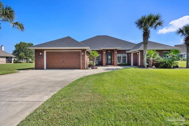 view of front facade featuring a front yard, concrete driveway, brick siding, and an attached garage