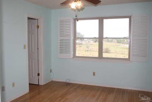 empty room with ceiling fan and light wood-type flooring