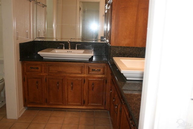 bathroom featuring vanity, tile patterned floors, and toilet