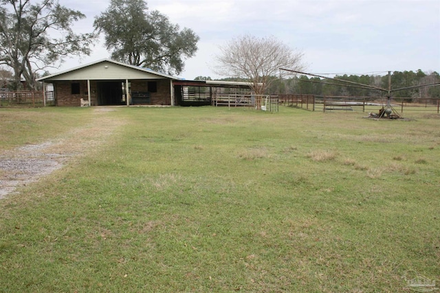 view of front of property featuring an outbuilding and a rural view