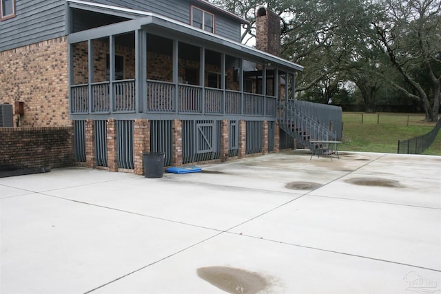 back of property featuring a patio and a sunroom